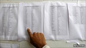 A man searches the passenger list for the names of relatives at the Pakistan Institute of Medical Sciences Hospital