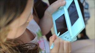 Girl playing on a Nintendo DS Lite Handheld computer games