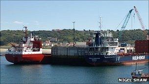 Two cargo ships berthed alongside the commercial quay at Braye Harbour