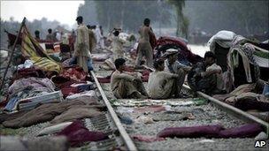 People sheltering on railway line in Nowshera, Pakistan (1 August 2010)