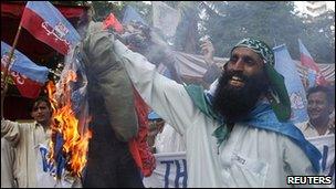 Protesters burn an effigy of David Cameron in Karachi