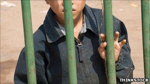 Generic image of boy behind bars