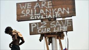 A Sri Lankan asylum seekers stands on a boat intercepted by Indonesian authorities en route to Australia