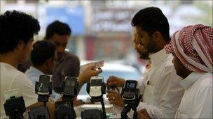 Men stand near Blackberry phones on sale at a shopping mall in Riyadh - 5 August 2010