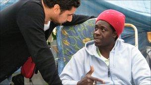 Kitchen worker Diaby Gandega gets advice from a union representative at a protest camp in Paris.