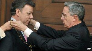 President Alvaro Uribe, right, decorates Colombia's President-elect Juan Manuel Santos with the National Merit Order