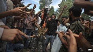 Protesters burn an effigy of Chief Minister Omar Abdullah