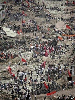 Rescue workers and residents search for survivors in Zhouqu, China, 10 August 2010