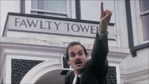 John Cleese as Basil Fawlty