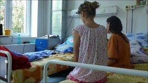 Nicoleta and Amalia sitting on hospital bed