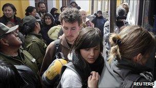 Foreign tourists board a bus to leave Potosi on 12 August