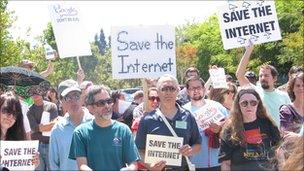 Protesters with "save the internet" signs