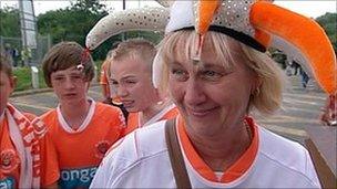 Fan Carol Bates wearing a jester hat