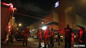 Soldiers and police stand outside the offices of Televisa in Monterrey