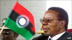 Malawi's President Bingu wa Mutharika waves the new flag at the launch of the new national flag on 7 August 2010