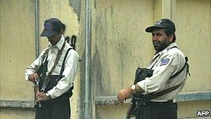 Private security personnel stand guard on a Kabul street (file photo)