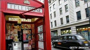 Prostitute calling cards in a London telephone box