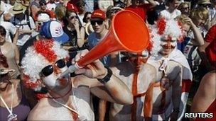 A man blowing a vuvuzela