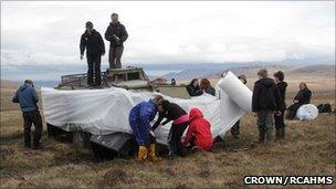 Children bubble wrap an APC at Cape Wrath. Image: Copyright Crown/RCAHMS