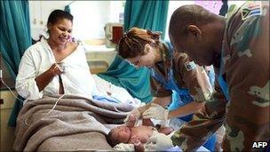 Army medics assist a patient at the labour ward of the King Edward VIII Hospital in Durban