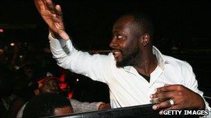 Wyclef Jean waves to supporters before the ruling is announced 20 Aug 2010