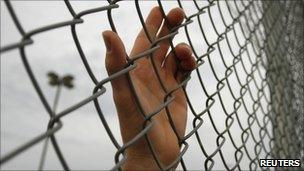 Stock image of hand on fence