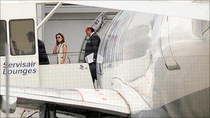 Asil Nadir and his wife Nur leave their plane at Luton Airport