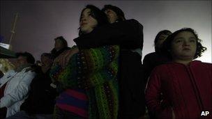 Relatives of the trapped miners watch the video (27 August 2010)