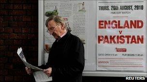 Man reading a newspaper outside Lords cricket ground