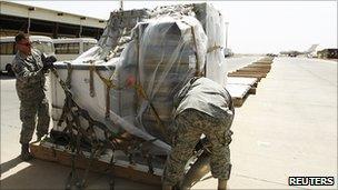 US soldiers pack equipment into an aircraft as they prepare to leave Iraq, 27 August 2010