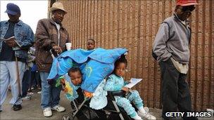 A homeless family standing outside of a shelter in Los Angeles, California