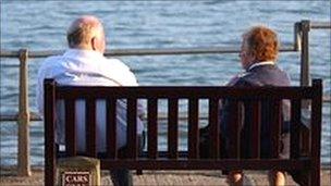 An elderly couple by the sea