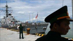 A Vietnamese guard stands near a US destroyer in the Vietnamese port of Danang on 10 August 2010