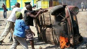Protesters overturn a burning car (2 September)