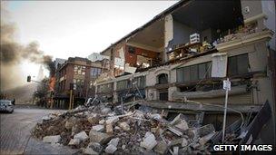 A damaged building and a building on fire in Christchurch, New Zealand, on 4 September, 2010