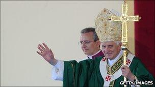 Pope Benedict XVI waves as he celebrates Mass in Italy, 4 July 2010