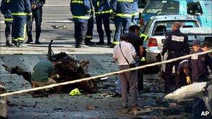 Policemen investigate the scene after an Eta car bomb exploded in Madrid, Wednesday, May 25, 2005