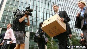 Lehman Brothers' employee carries his belongings away from the bank after its demise in September 2008