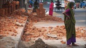 Female worker next to brickmakers