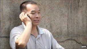 Chinese man chats on his mobile phone in Beijing