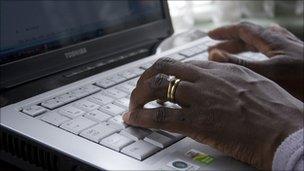 Woman typing on laptop computer