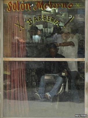 A barber works in a salon in Havana on 7 September 2010