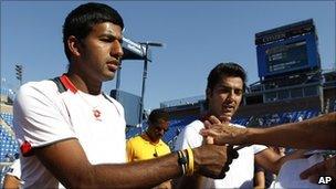 Rohan Bopanna of India, left, and partner Aisam-Ul-Haq Qureshi of Pakistan sign autographs after winning their semifinals doubles match during the US Open tennis tournament in New York, Wednesday, 8 September 2010