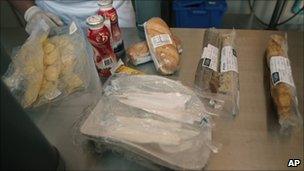 A cook shows food that will be sent through a pipe to miners trapped at the San Jose mine in Copiapo, Chile