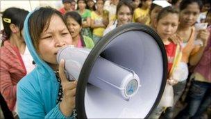 A worker shouts into a speaker on Phnom Penh on 13 September 2010