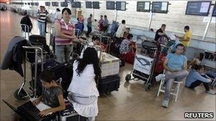 Passengers wait at Ben-Gurion airport, 13 September