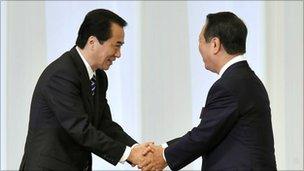 Naoto Kan (L) shakes hands with Ichiro Ozawa (R) after the leadership vote on 14 September 2010