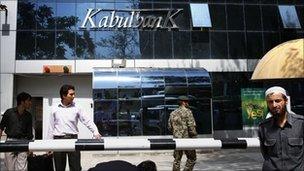 Men walk outside Kabul Bank