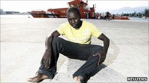 A would-be immigrant rests after arriving at the port of Motril, southern Spain, 10 August 2010