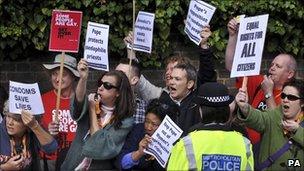 Protesters wave banners